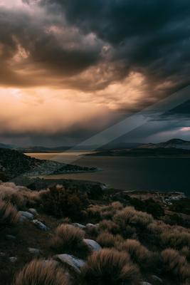 A dramatic long exposure sky scene of storm, lake.