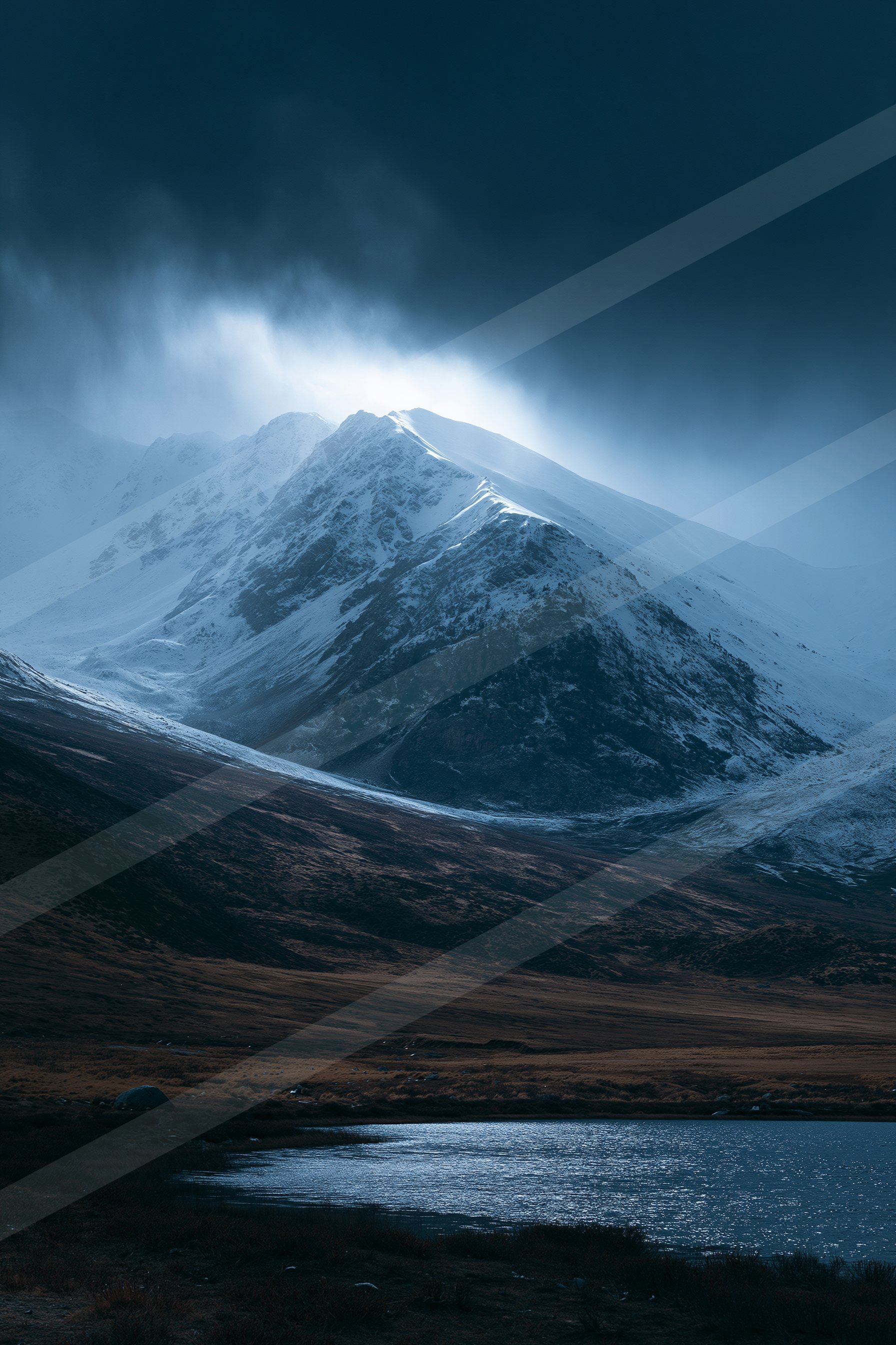 A moody high contrast landscape of a mountains, snow.