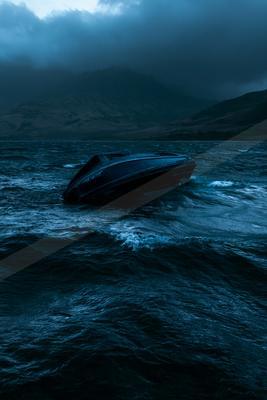 A black-toned moody photograph of speedboat, wreck, lakeside.
