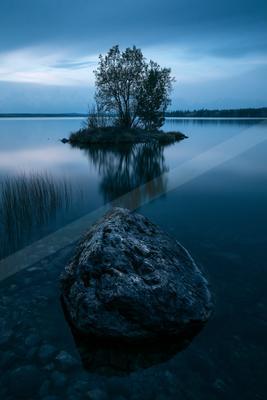 A blue hour high contrast water scene of a lake, reflection.