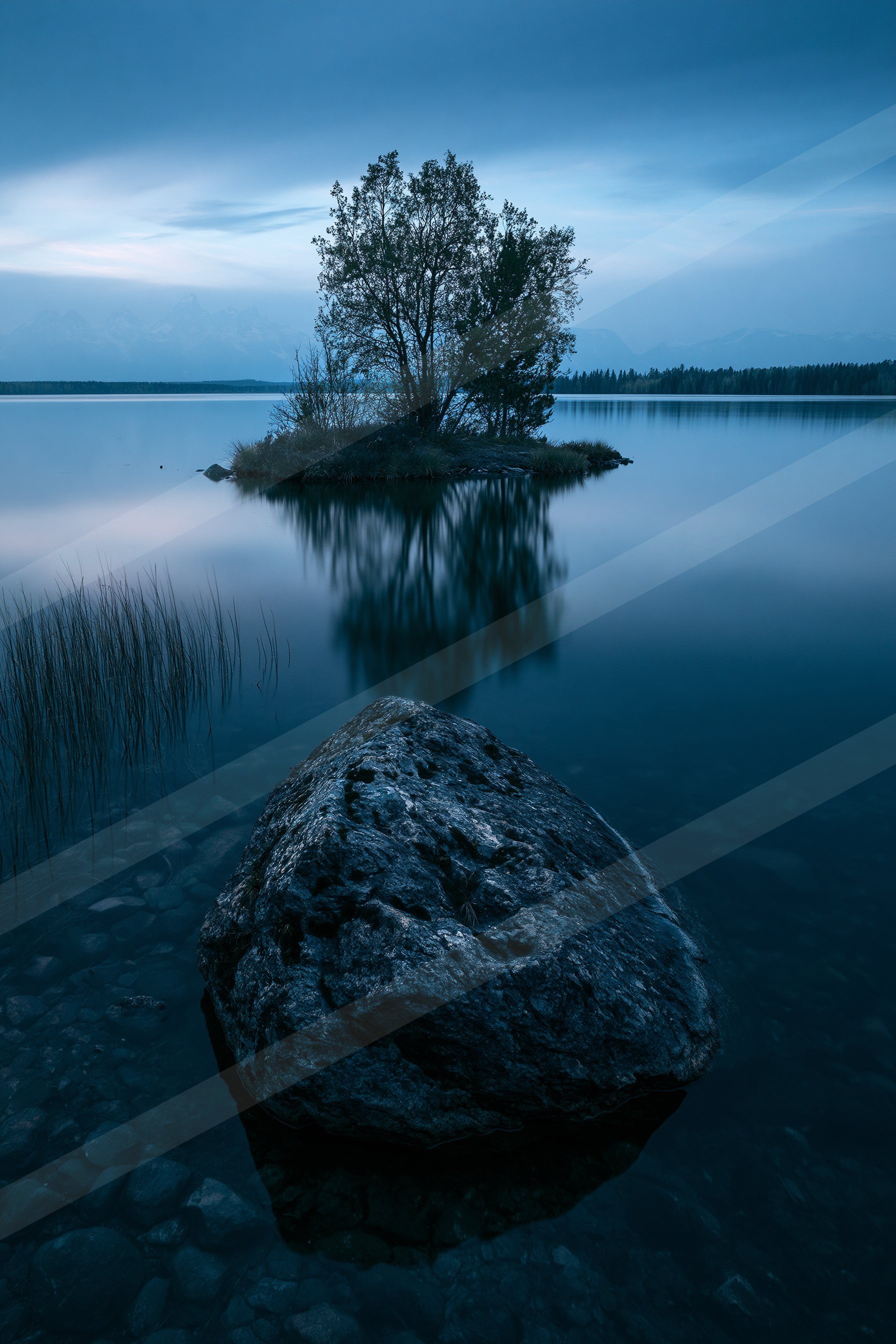 A blue hour high contrast water scene of a lake, reflection.