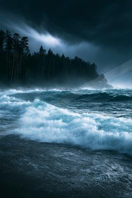 A turbulent ocean scene at night with crashing waves and a dark forested coastline under storm clouds.