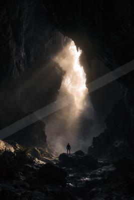 A black-and-white moody landscape of mountains.