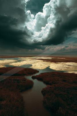A moody sky scene of storm, clouds, river.