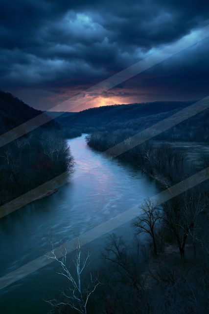 A blue hour panorama water scene of a river, fog.