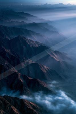 An ethereal panorama landscape of a mountains, fog.