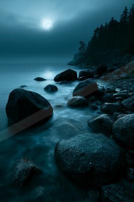 A blue hour long exposure water scene of ocean, river, lake.
