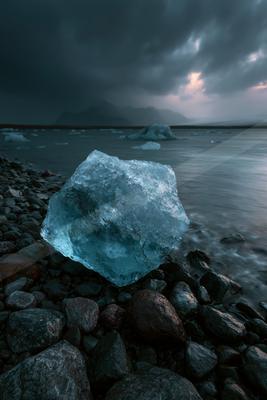 A blue hour water scene of ocean, rocks.