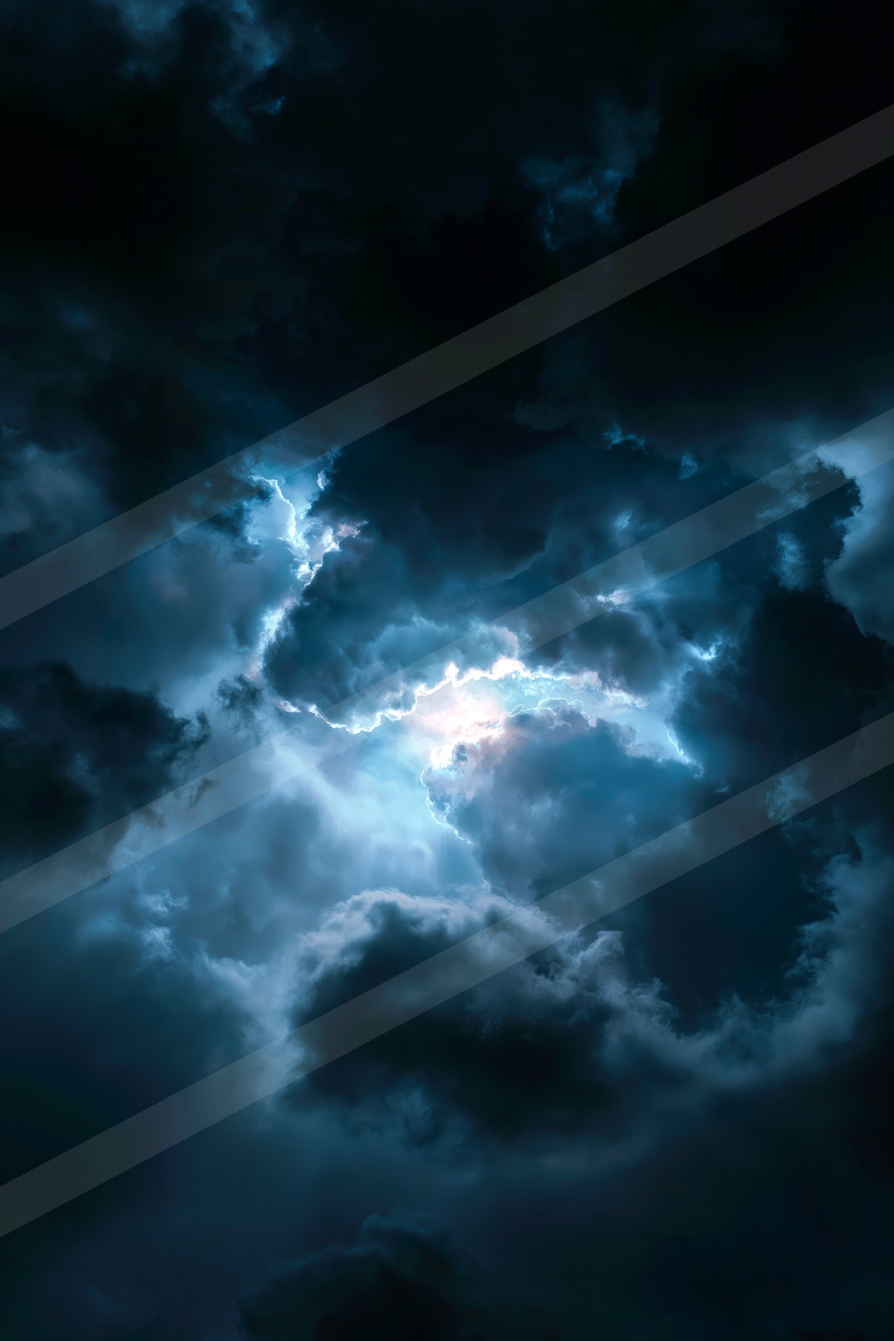 A powerful lightning bolt illuminates dark storm clouds during a thunderstorm.