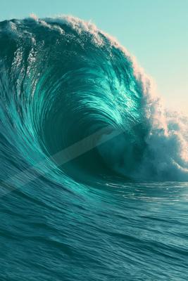 A massive turquoise ocean wave curls powerfully with a hollow barrel and white foam crest against a clear sky.