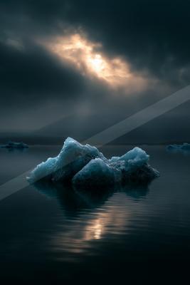 A blue hour water scene of lake, clouds.