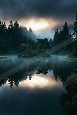 An ethereal double exposure water scene of a lake, reflection.