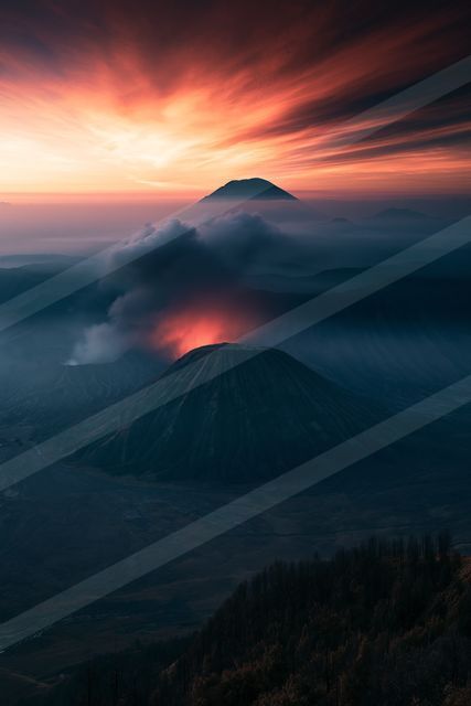 A moody landscape of mountains, sunrise.