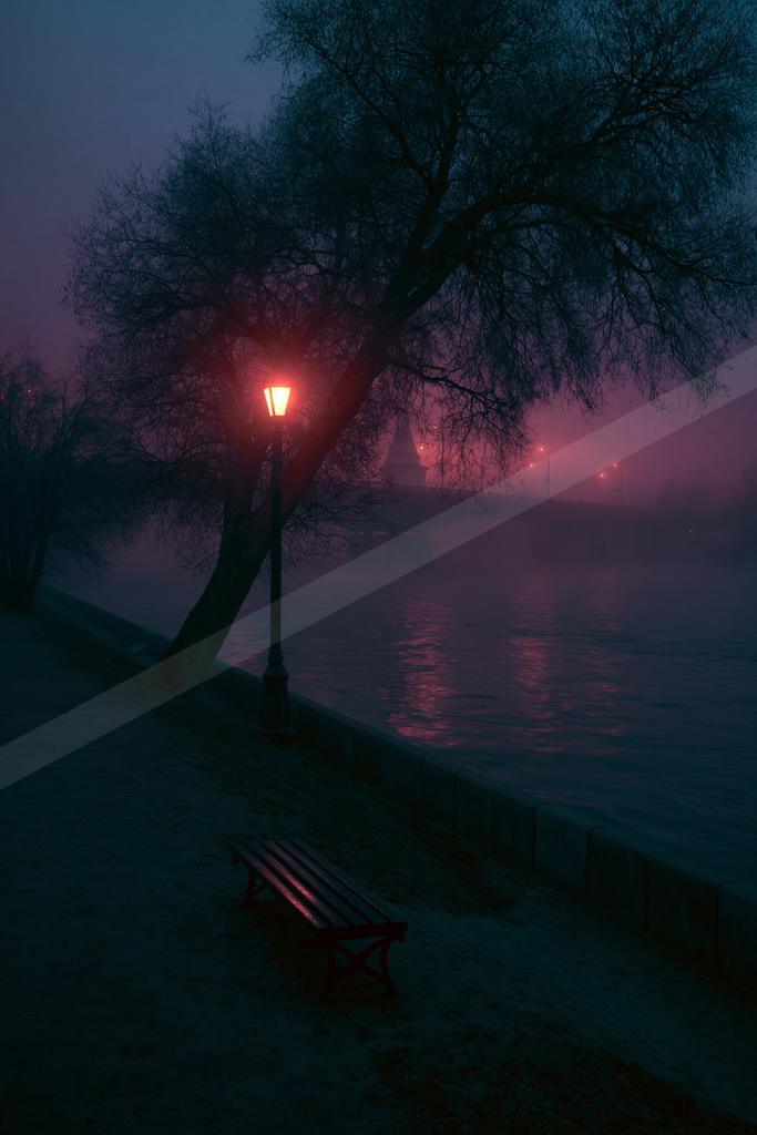 A wooden bench sits on a snowy riverbank beside a glowing red street lamp and a bare tree, with dense pink and purple fog over the water at night.