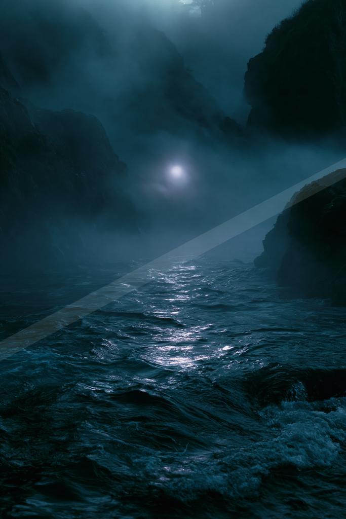 A moody water scene of ocean, waterfall.