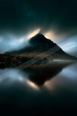 A moody landscape of mountains, lake.