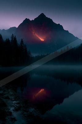 A dramatic mountain peak with a glowing red volcanic fissure is reflected in a calm, misty lake surrounded by a dark forest under a purple twilight sky.