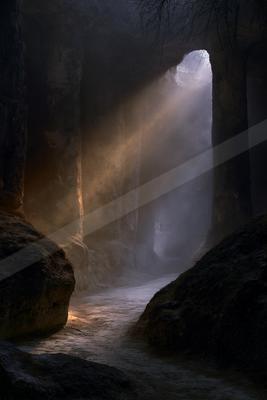 A black-and-white moody water scene of waterfall.