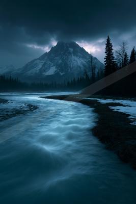 A blue hour long exposure water scene of river, mountains.