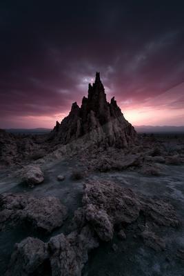 A moody landscape of desert, mountains.