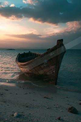 A brown-toned moody photograph of wreck, seashore, sandbar.