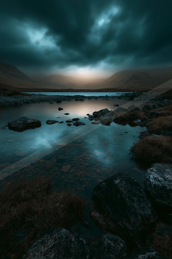A blue hour long exposure water scene of lake, storm, clouds.