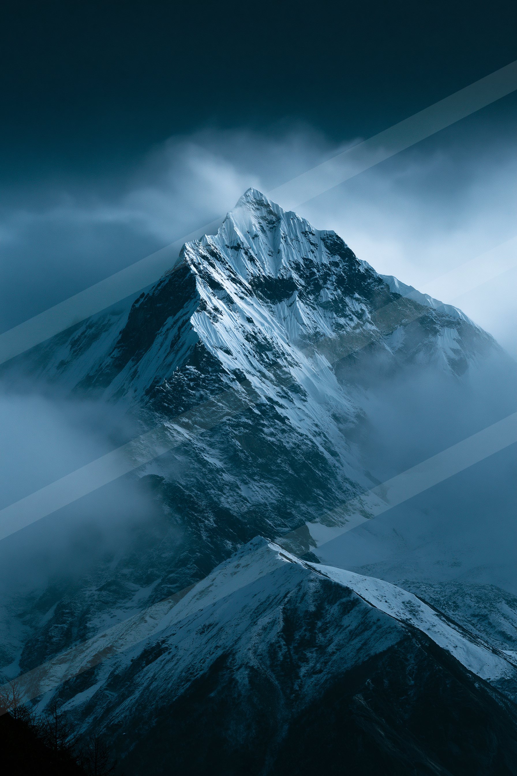 A towering snow-covered mountain peak piercing through a dense layer of clouds, creating a dramatic and atmospheric scene.