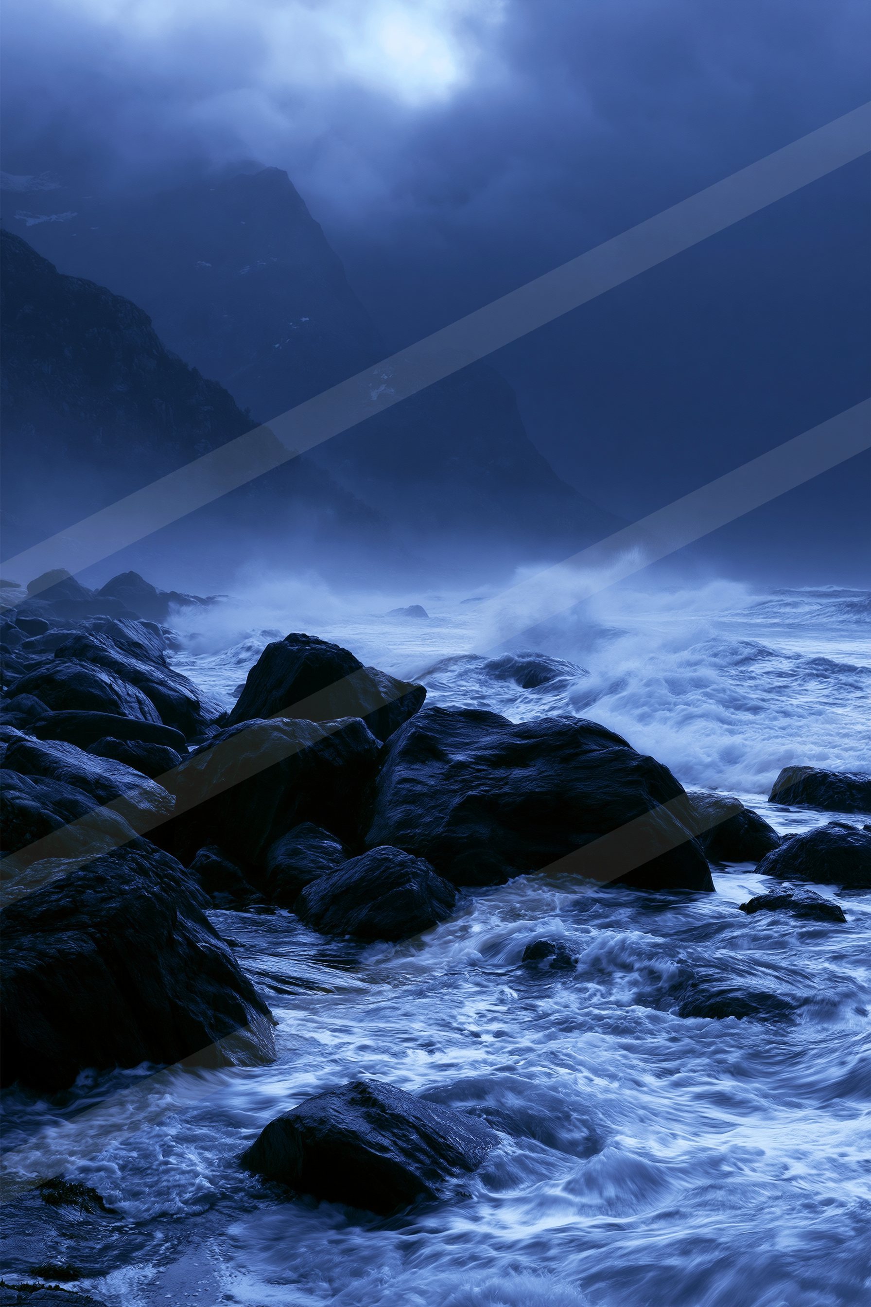 A blue hour high contrast water scene of an ocean, fog.