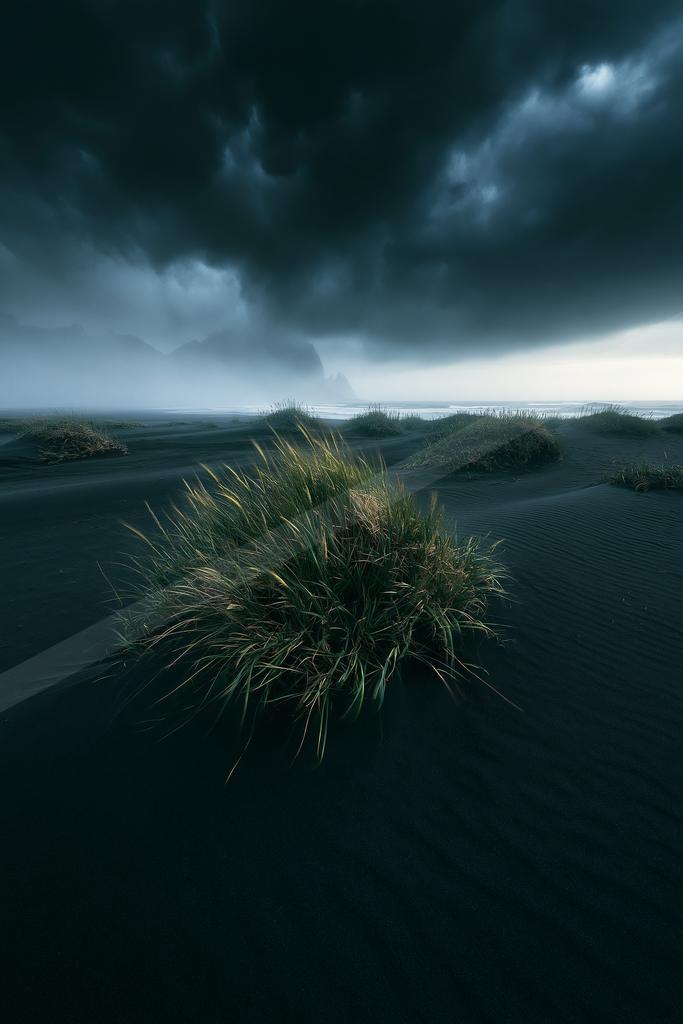 A moody sky scene of storm, field, lake.