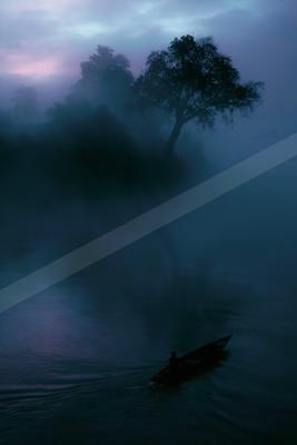 A blue hour water scene of lake, river, fog.