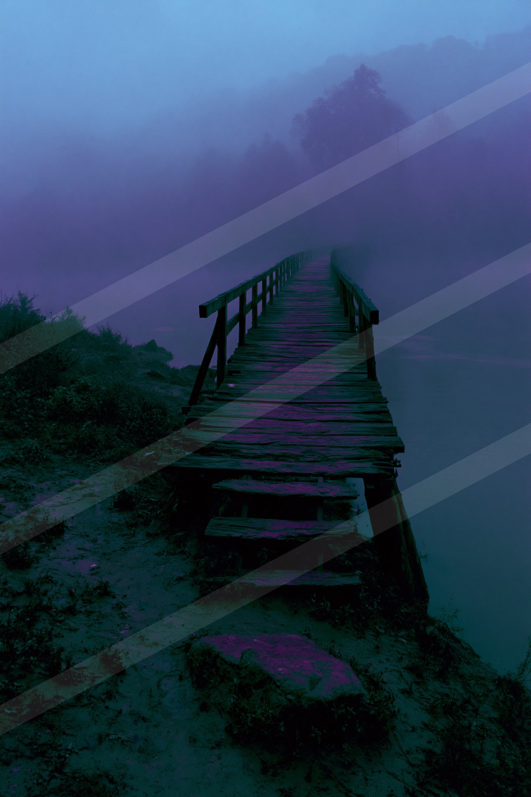 A mysterious leading lines water scene of a lake, fog.
