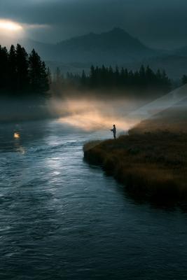A blue hour long exposure water scene of river, lake, fog.