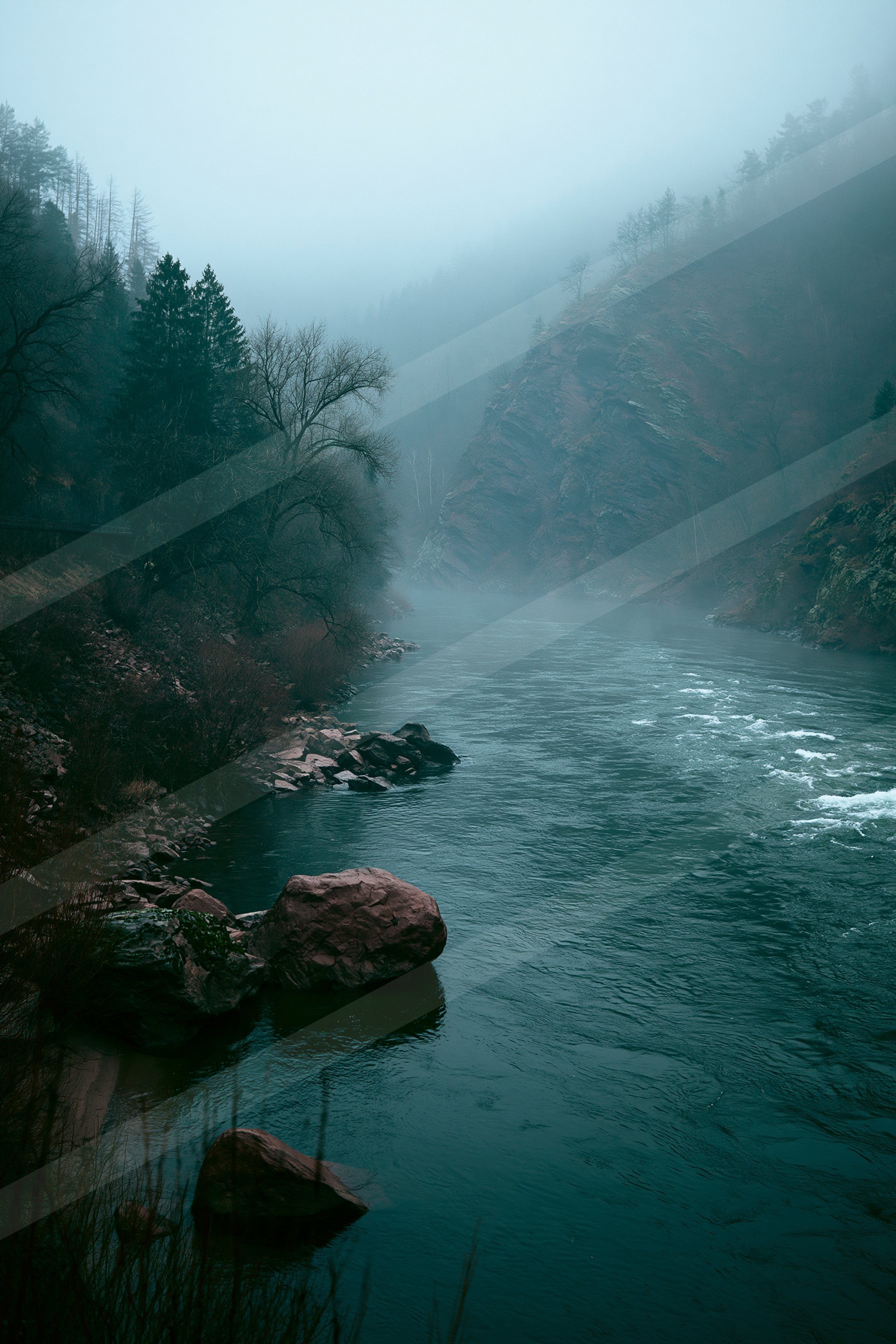 A serene river flows through a mist-covered canyon surrounded by rocky cliffs and dense forest, creating a tranquil natural scene.