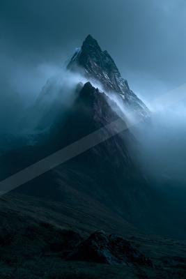 A moody landscape of mountains.