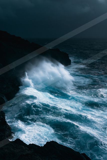 A dark and moody seascape featuring turbulent ocean waves crashing against jagged rocky cliffs under a stormy night sky.