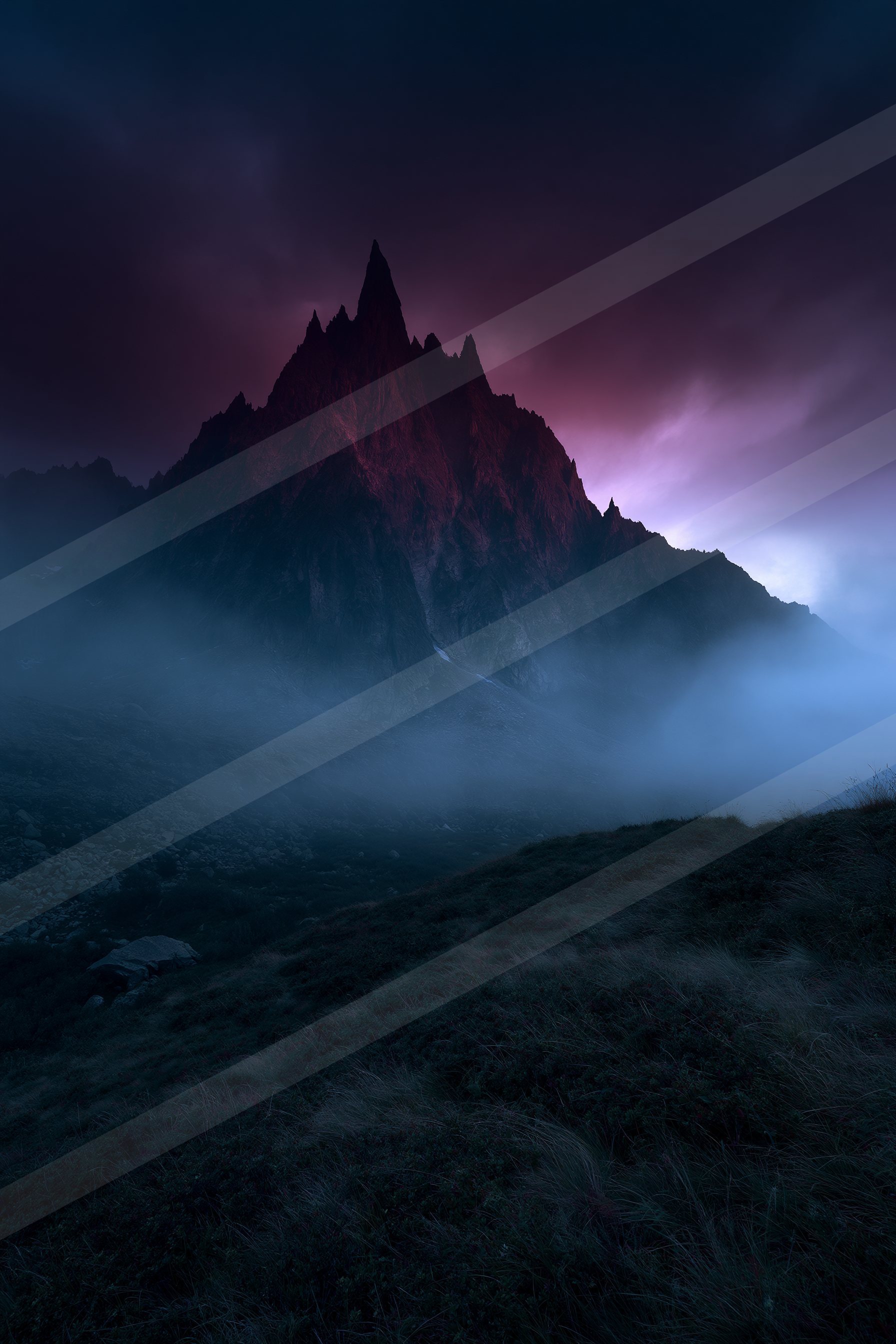 An ethereal landscape of a mountains, fog.