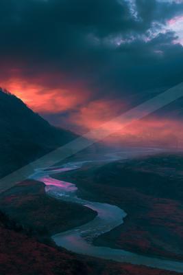 A blue hour water scene of river, valley, mountains.