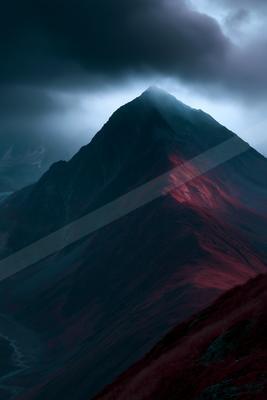 A dramatic landscape of mountains, storm.