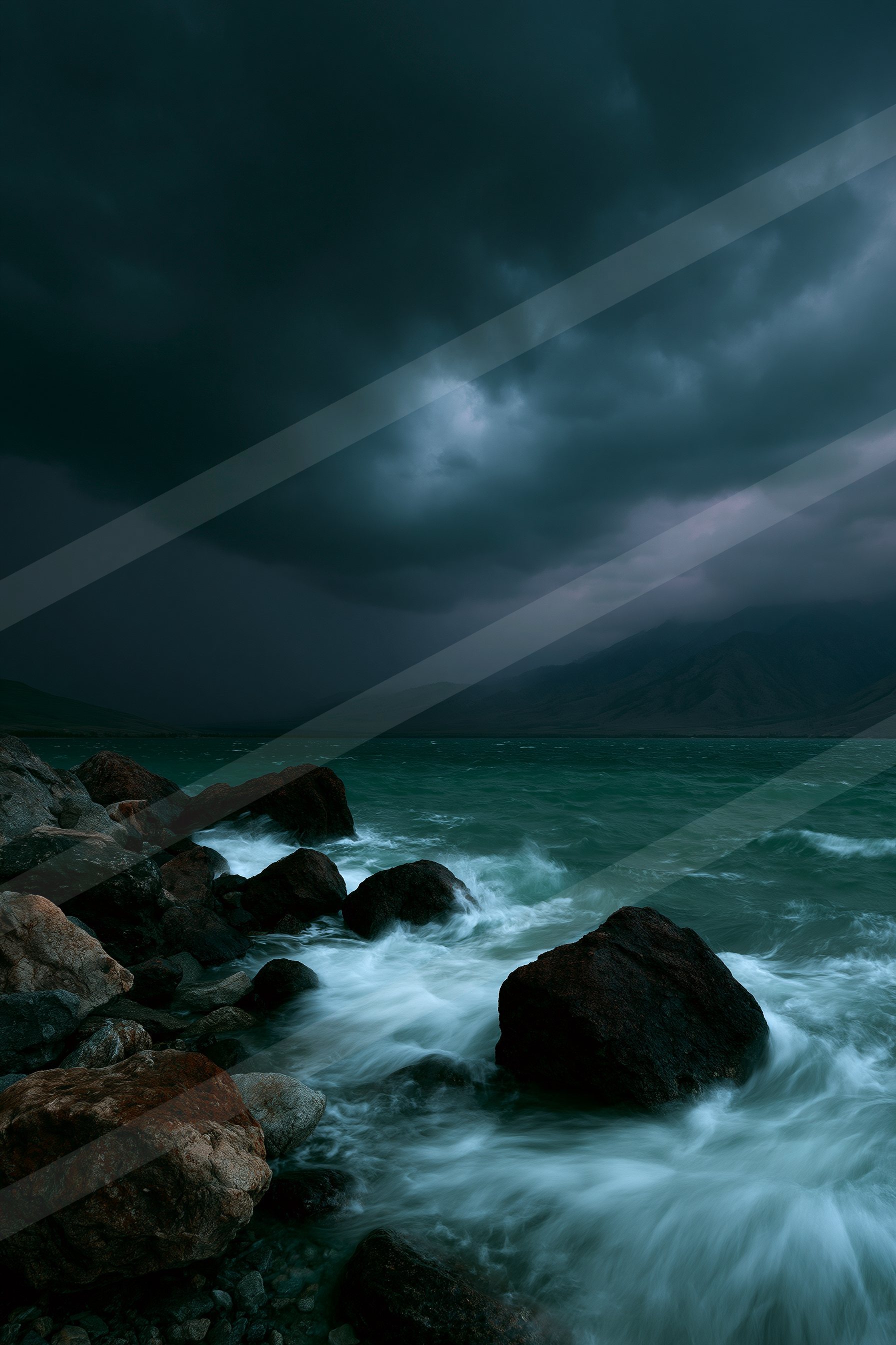 A dramatic long exposure water scene of an ocean, rocks.