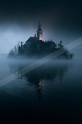 A night water scene of lake, fog.