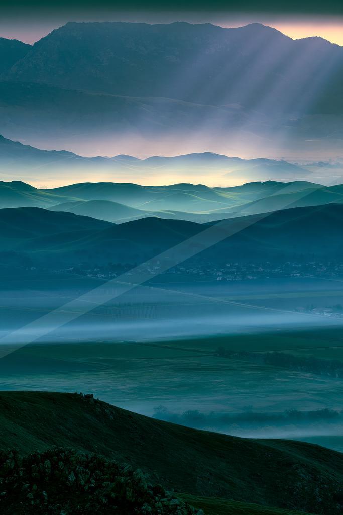 A blue hour landscape of mountains, valley.
