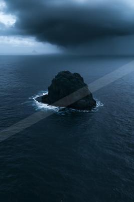 A dramatic water scene of ocean, storm, rocks.