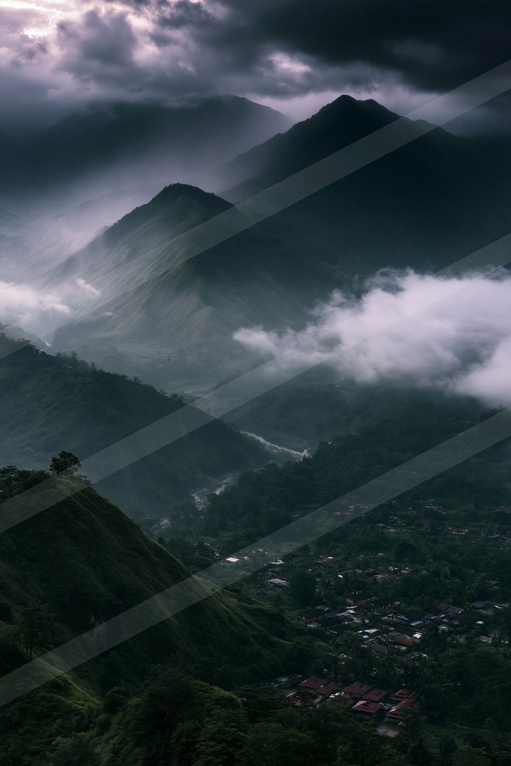 A dark, atmospheric view of mist-covered mountains overlooking a serene valley with a small village nestled among lush greenery.