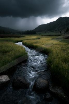 A dramatic long exposure water scene of river, valley, storm.