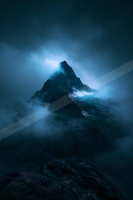 A moody landscape of mountains.