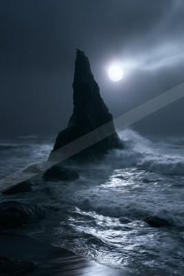 A brown-toned moody photograph of seashore, promontory, beacon.