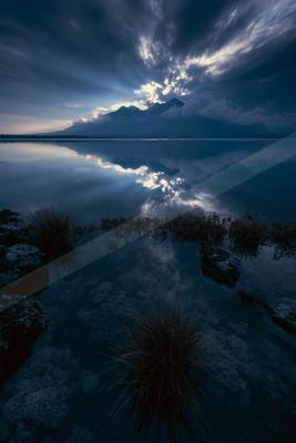 A blue hour long exposure water scene of lake, reflection.