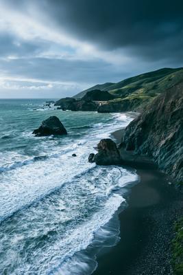 A bright water scene of beach, ocean.