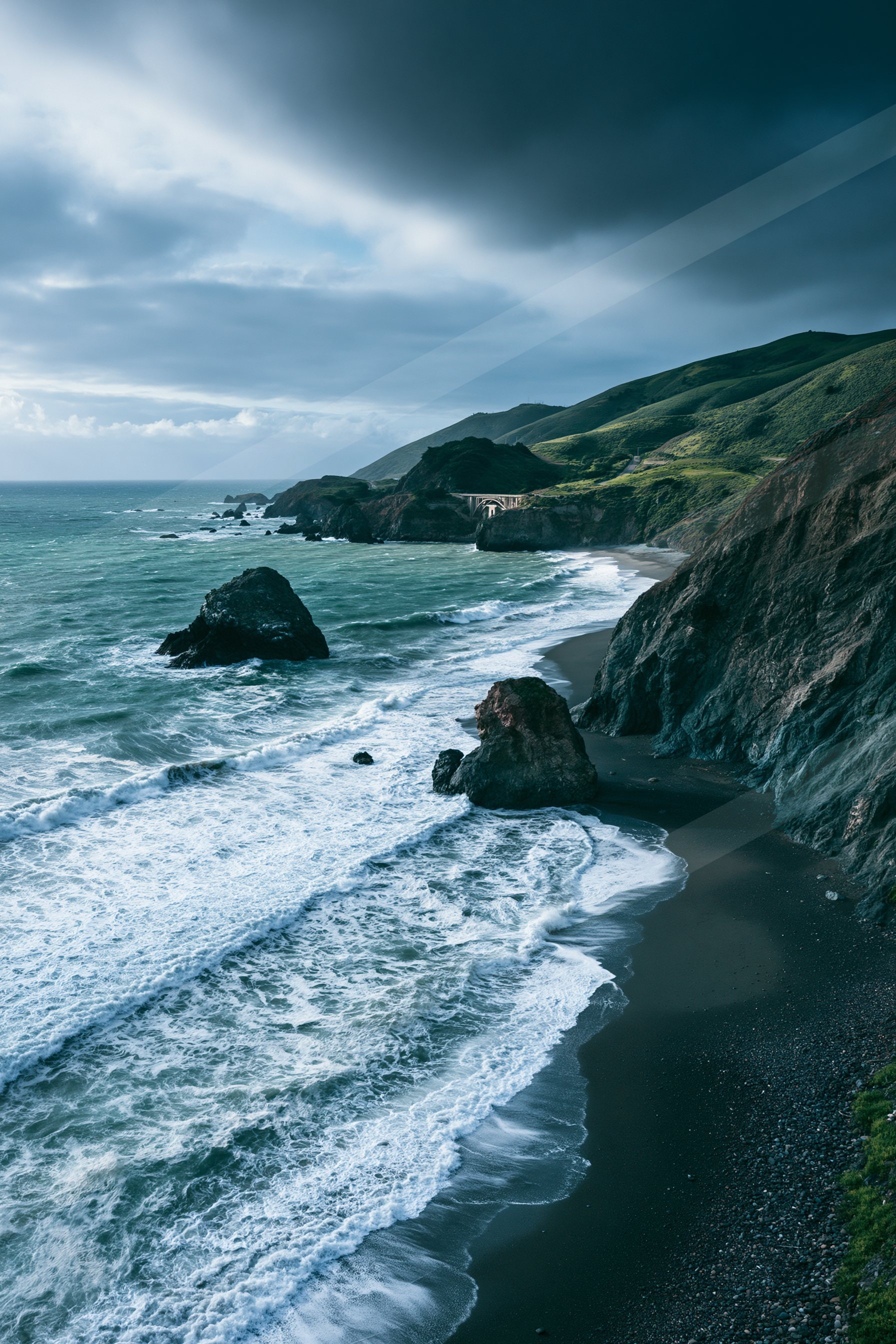 A moody high contrast water scene of a coastline, sand.
