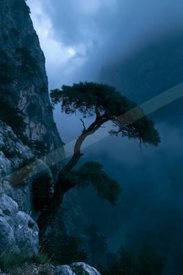 A blue hour sky scene of storm, mountains, valley.
